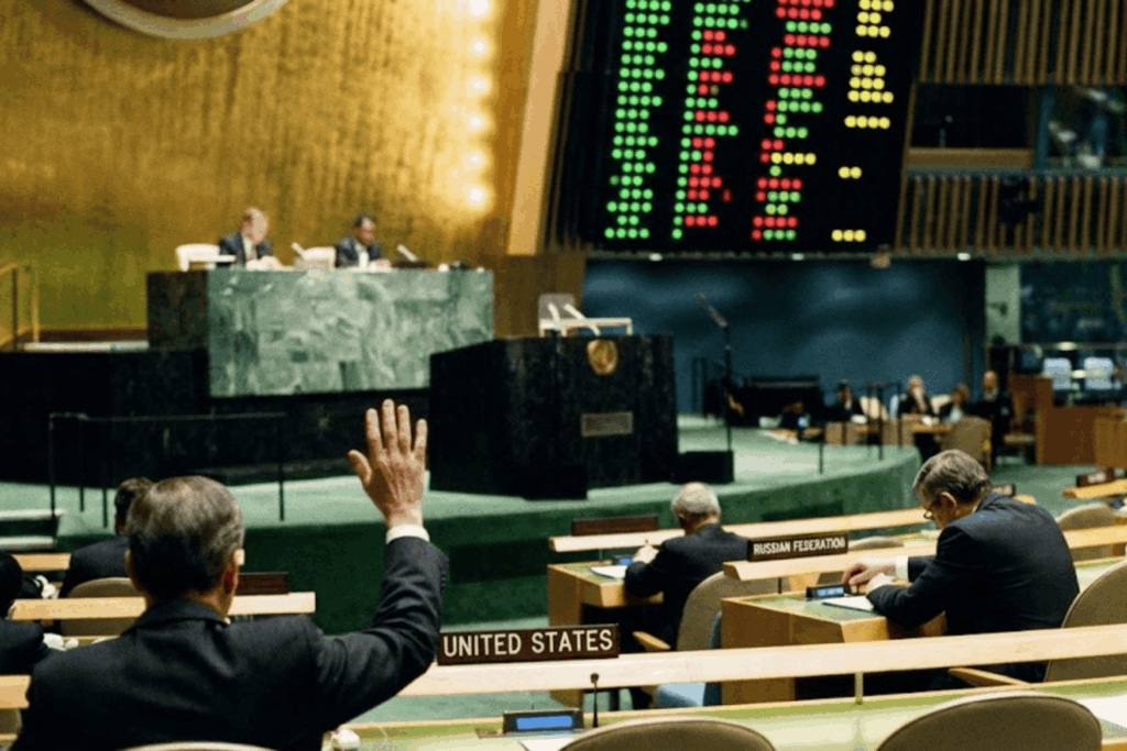 Two delegates, one from the United States and one from Russia, seated several rows apart at the UN./